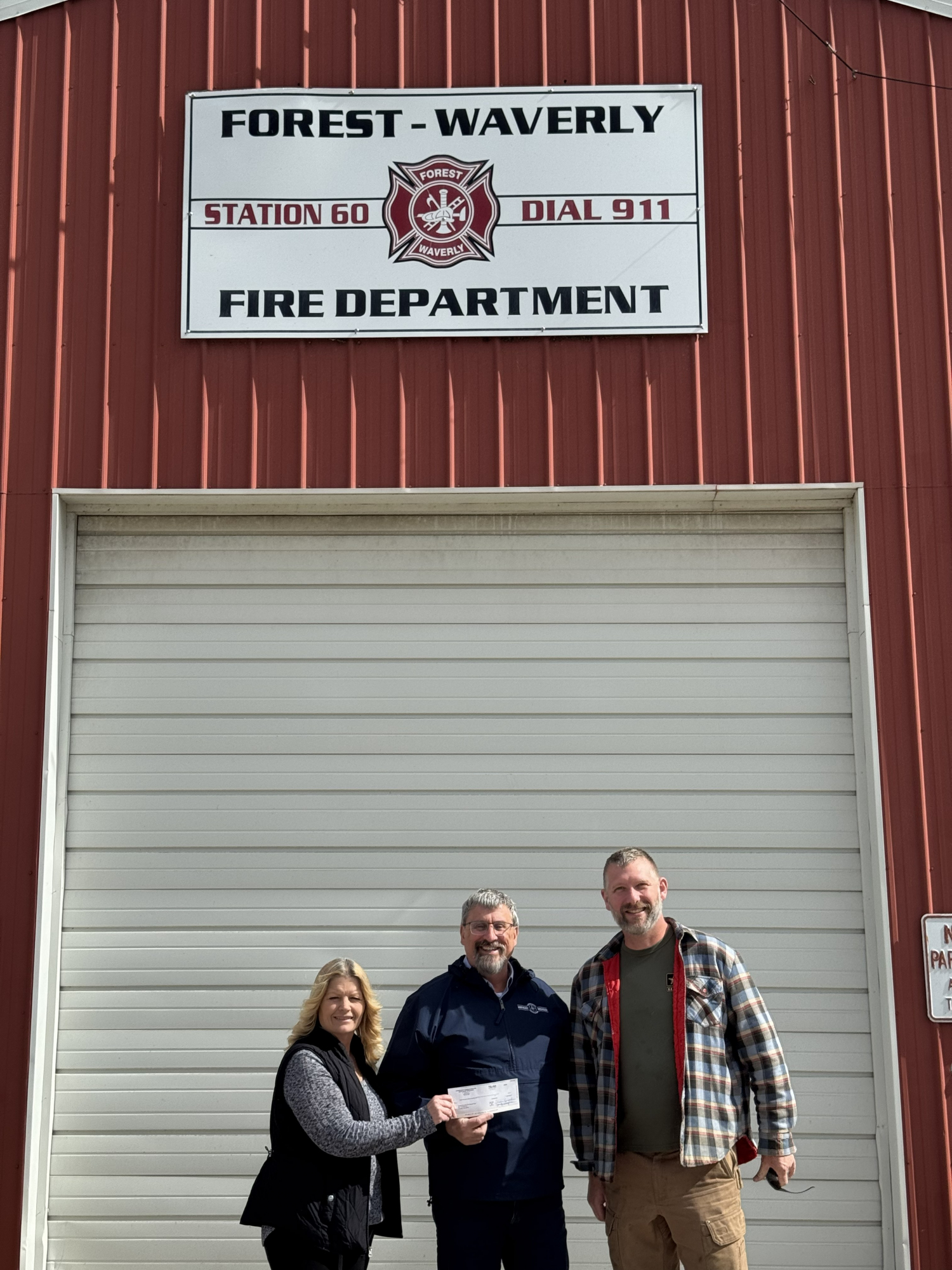 SACF board member Patty Archambo delivers a grant check to Forest Waverly Township Fire Department.