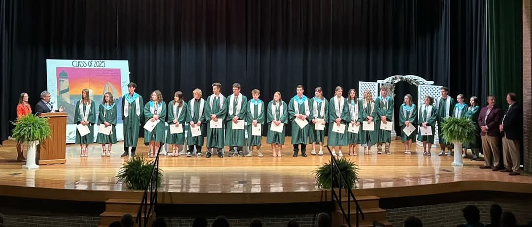 CFNEM Executive Director Patrick Heraghty and CFNEM Program Director Jennifer Dingman announce scholarships during the Alpena High School awards ceremony in May 2025.