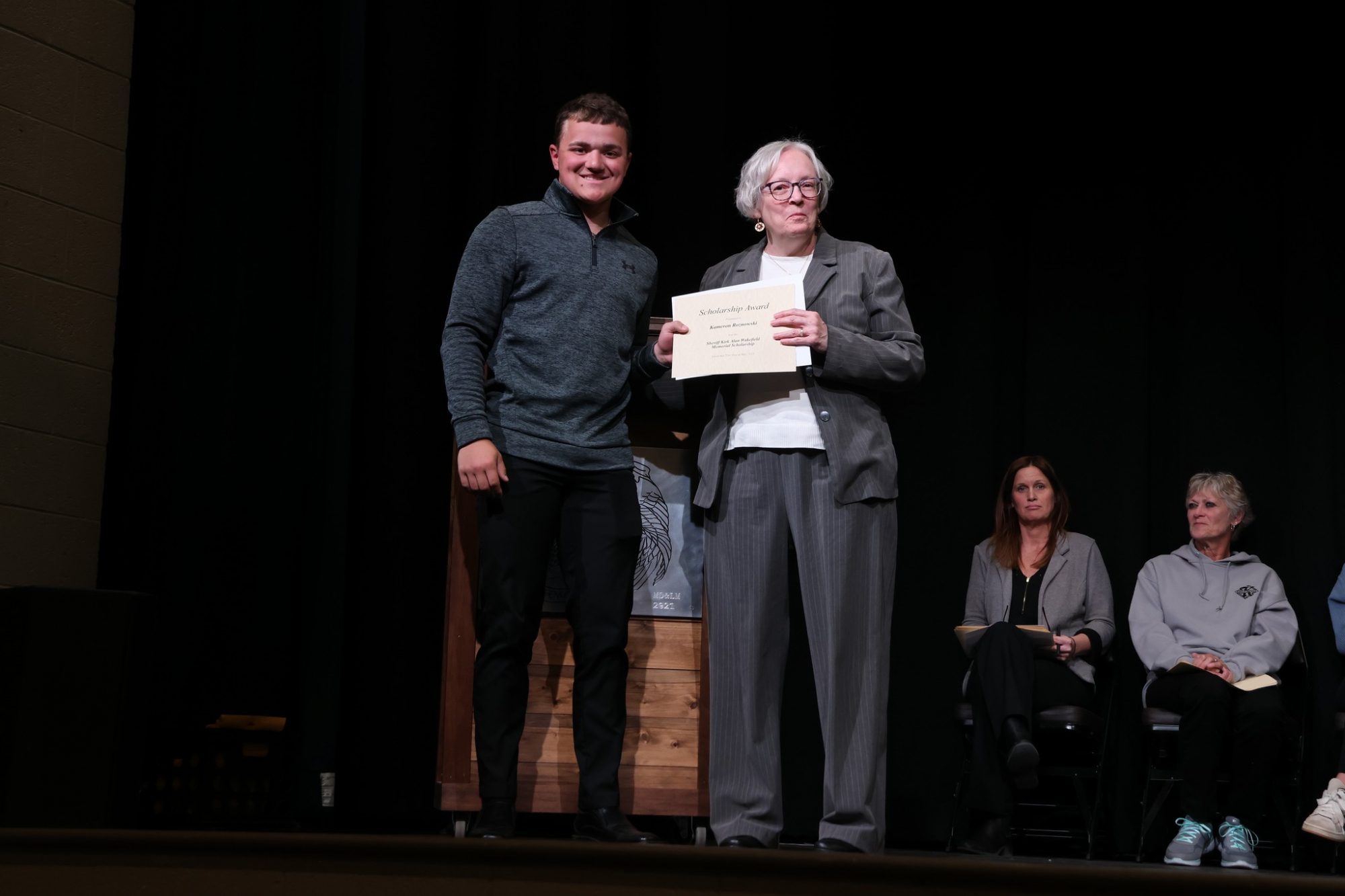 NCMCF Board Member Jozann Burgin presents the Sheriff Kirk Alan Wakefield Memorial Scholarship to Kameron Roznowski, an Ogemaw Heights High School graduate.